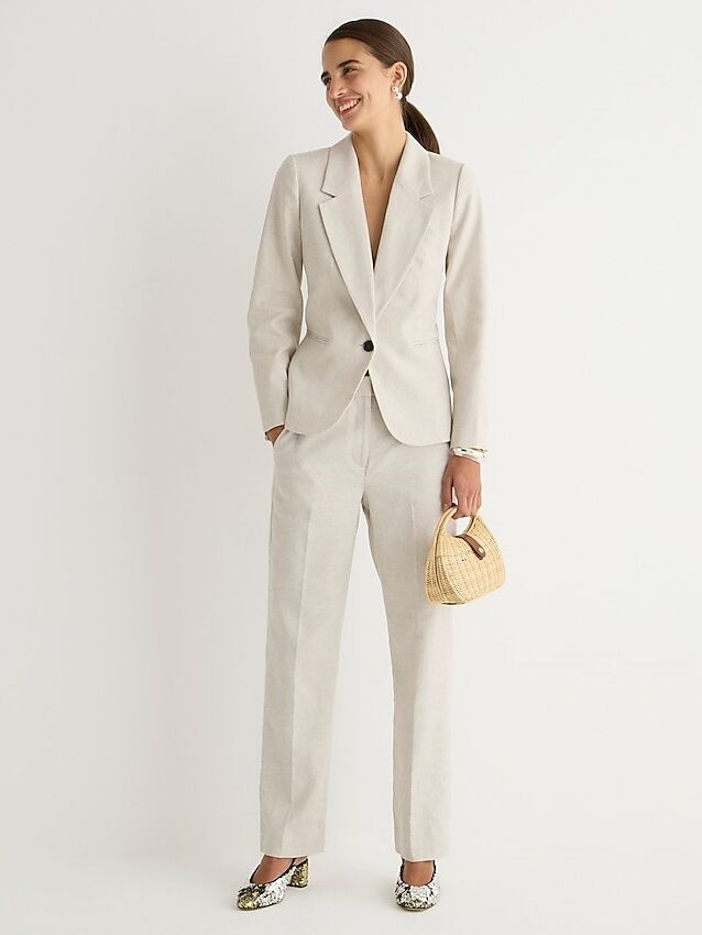 Model wears a white linen pantsuit. 