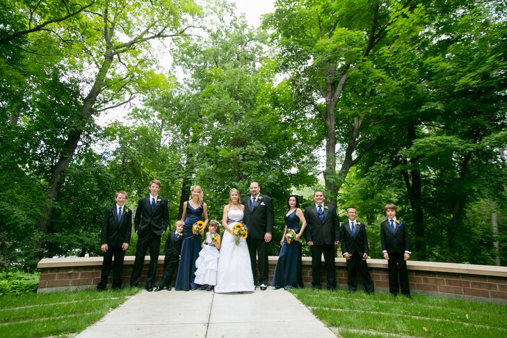 Dawn's bridesmaids wore floor-length dresses in deep navy from David's Bridal for this summer event. The groomsmen sported black tuxedos from Men's Wearhouse along with blue vests and blue ties. Dawn and Chad's wedding party included their nieces and nephews.