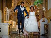 couple jumping the broom during wedding ceremony