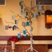 Guests found their teal, gray and white escort cards hanging from branches of a gold decorative tree, guiding them in the direction of their seats. This glamorous piece went along with the glamorous style that Cassandra combined with the peacock-inspired decor.