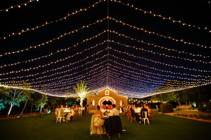 The newlyweds’ dinner reception was held in the Flora Farm’s mango grove under a tent of string lights. “The entire farm was glowing, and we ate and drank under the stars,” the bride says. Taylor and Cory dined at a romantic sweetheart table that was embellished with greenery, pink peonies, candles and lanterns. “It might have been the dreamiest table ever!”