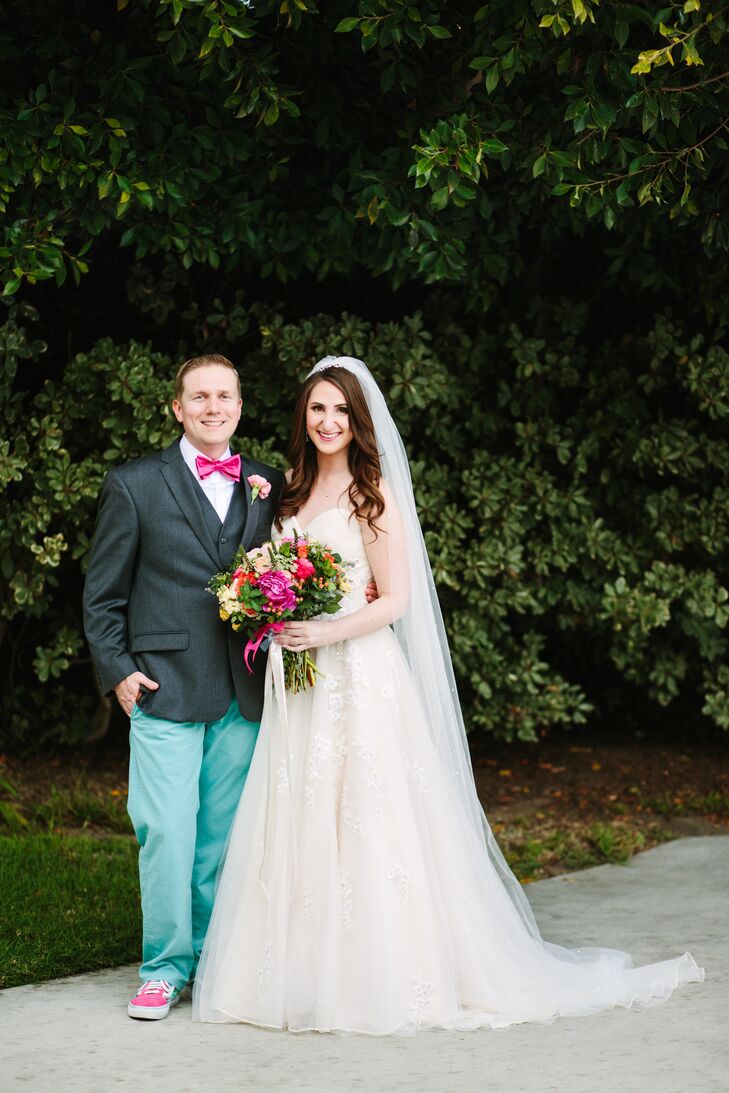 “We were most inspired by the look of our venue and wanted to bring lots of color into the reception hall to match the beautiful ocean vistas,” says Thadd, who wore teal pants and a pink bow tie to echo the vibrant colors in the florals and bridesmaid gowns.