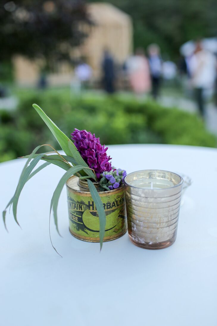 Metal vases filled with candles and bright flowers decorated tall white cocktail tables where guests rested their drinks, including Maine craft beers, as they meandered around the farm.