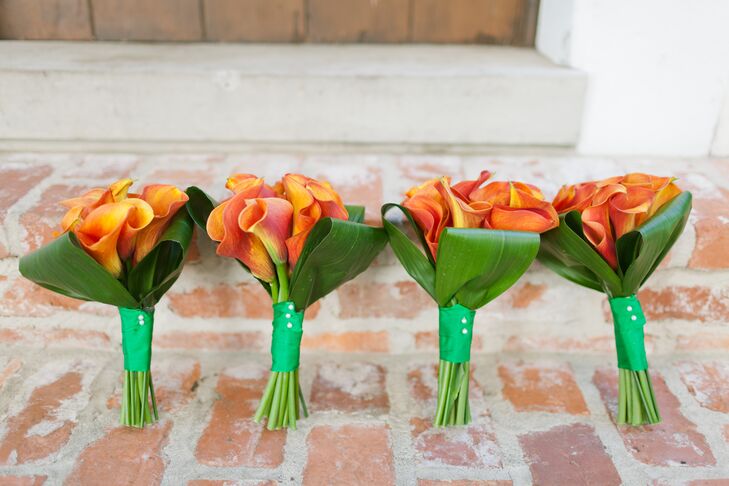 Windermere Flowers and Gifts designed arrangements of orange calla lilies and bold green leaves for the bridesmaids. Each bloom brought our Marie and Josh's wedding color as well as added a touch of spring to their February wedding.