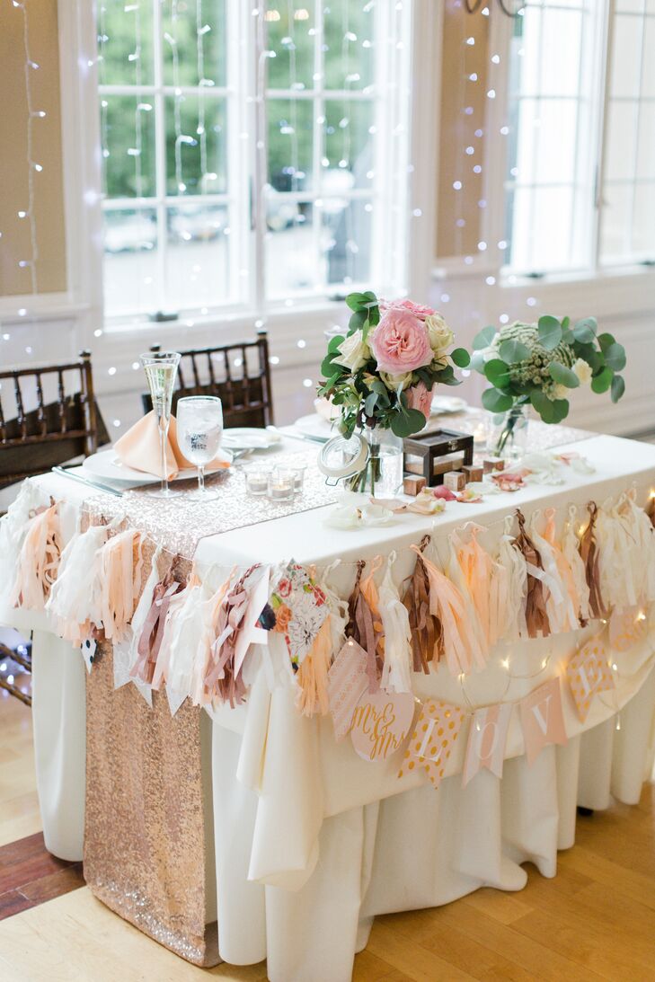 Priscilla and Daniel covered the sweetheart table with decor. On top of a DIY tassel banner, mixed pattern love sign and rose gold-sequin runner, the couple set up a backdrop for their reception. "The string lights made the space look even more magical and delicate, setting the mood for our theme,” Priscilla says.