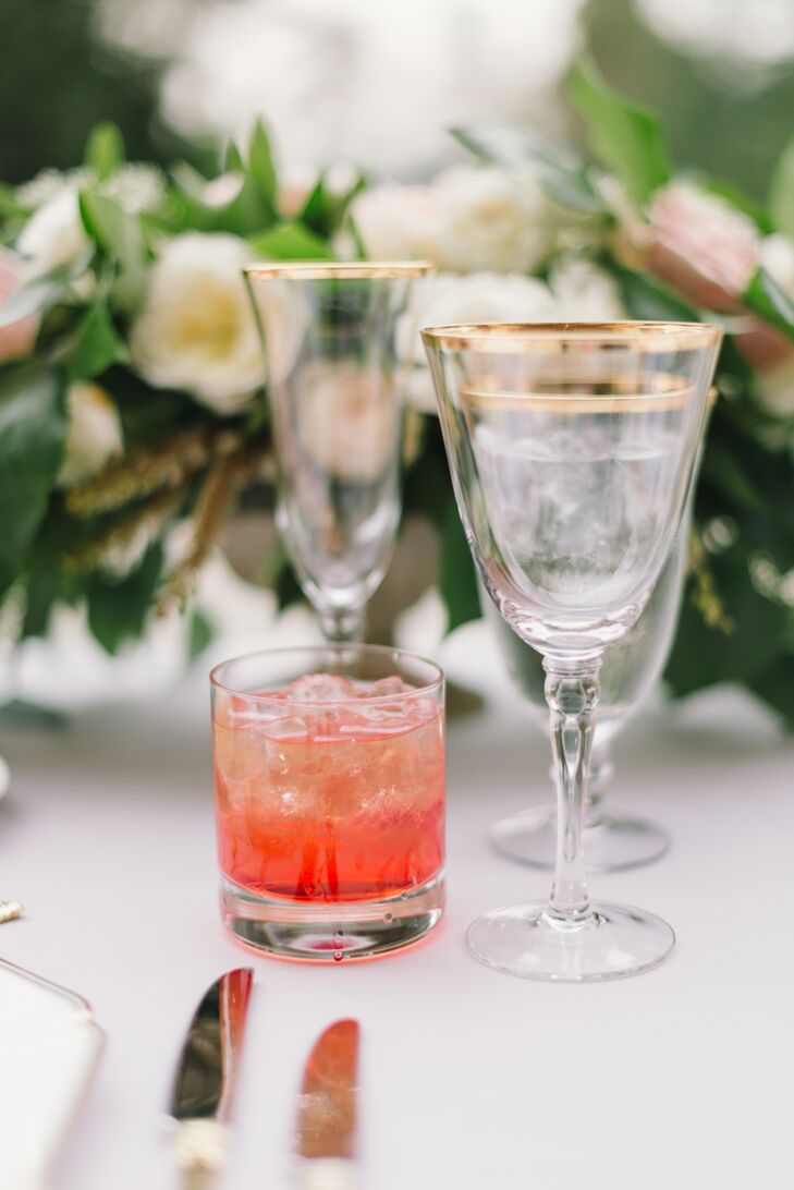 Light gray linen-covered tables were set with gold-­accented ivory china, elegant gold flatware and gold­-rimmed glassware at the reception at Montalvo Arts Center in Saratoga, California.