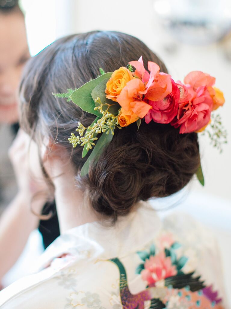 wedding hair flowers colorful floral barrette above low bun