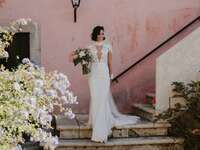Photo of bride holding bouquet on steps