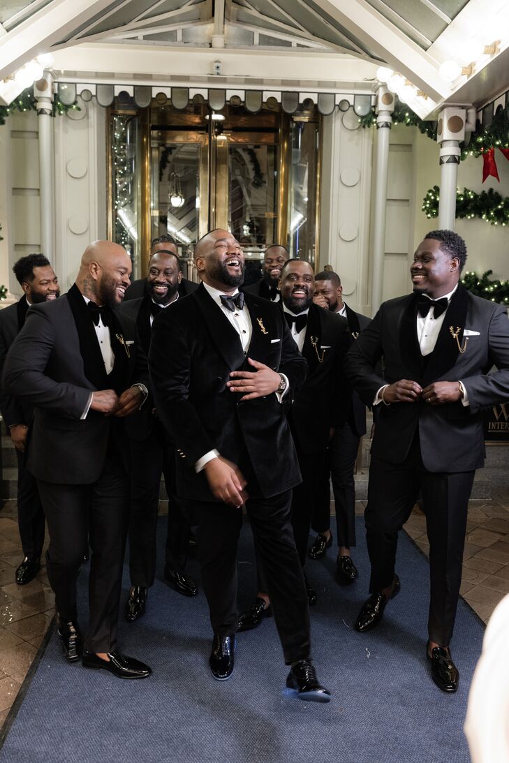 Groom and Groomsmen in Tuxedos Laughing Together
