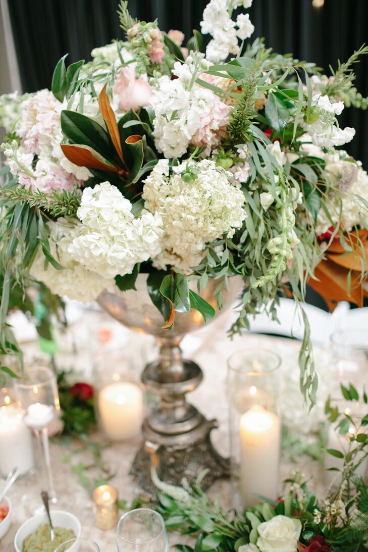 Talk about bringing the outside in. Hydrangeas, roses and magnolia leaves topped the reception tables for the ultimate botanical look. Brianna from Fox & Fern Floral had artistic control over the reception, and Claire and Rob couldn't have been happier with the outcome.