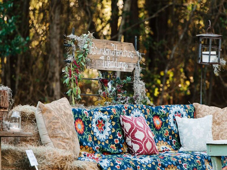 Rustic hay bale seating area at backyard wedding
