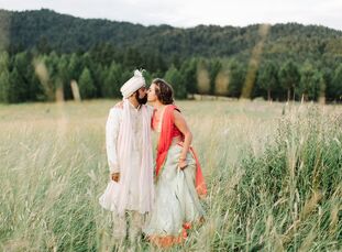 Sarah Bowen and Neil Patel wed on the bride's brother's property in Moscow, Idaho, blending their family traditions into a unique and colorful Western