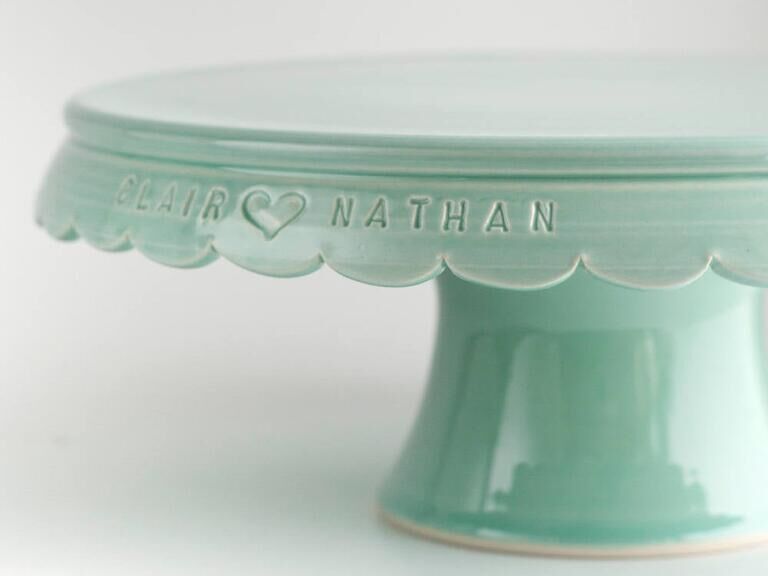 Mint green vintage-style wedding cake stand engraved with couple's names
