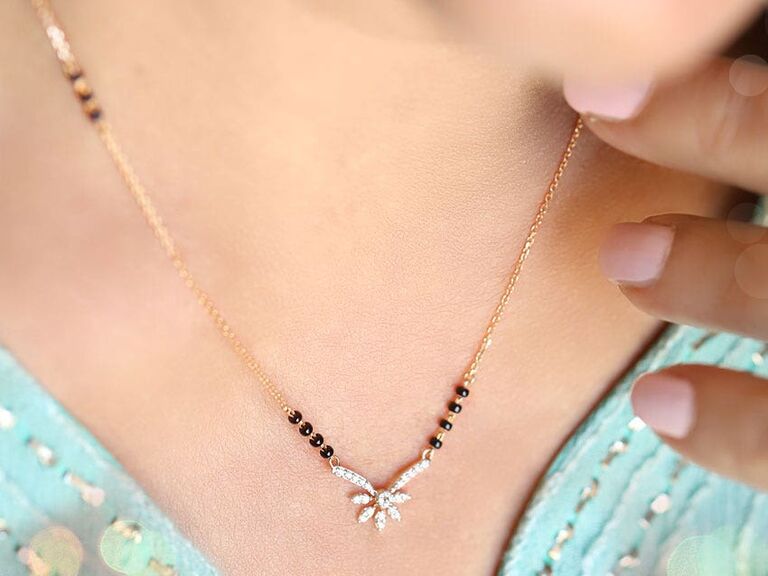 Dainty gold necklace with diamond charm. 