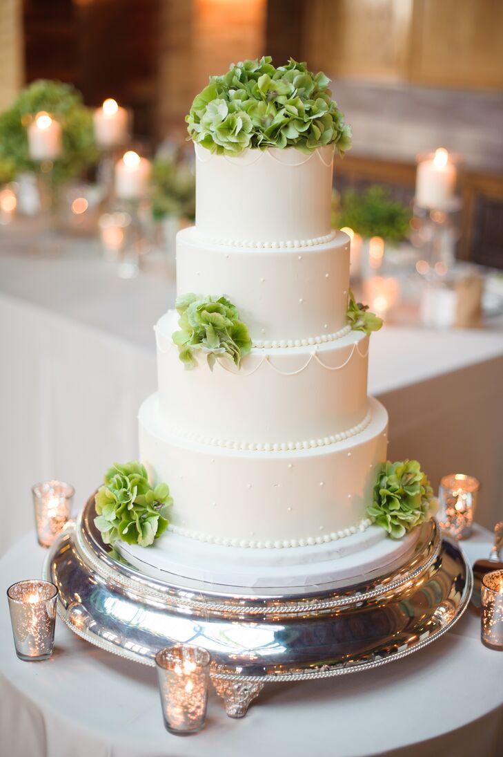 Bittersweet Pastries baked up this four-tier green and white confection for the couple, complete with fondant and green hydrangeas.