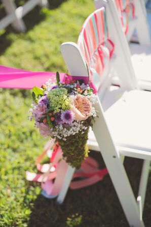 Bright Floral Aisle Markers in Moss Vases