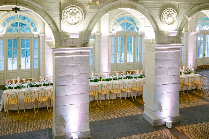 Long Reception Table, White Linen and Greenery Runner in Boathouse With Uplighting