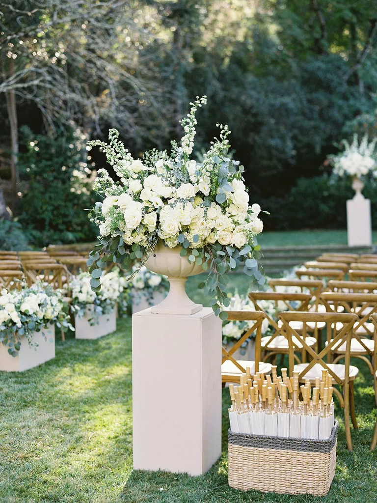 A statuesque floral arrangement in cream and green.