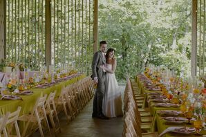 Bride and Groom Looking at Gazebo Reception Tables of Yellow, Pink and Orange