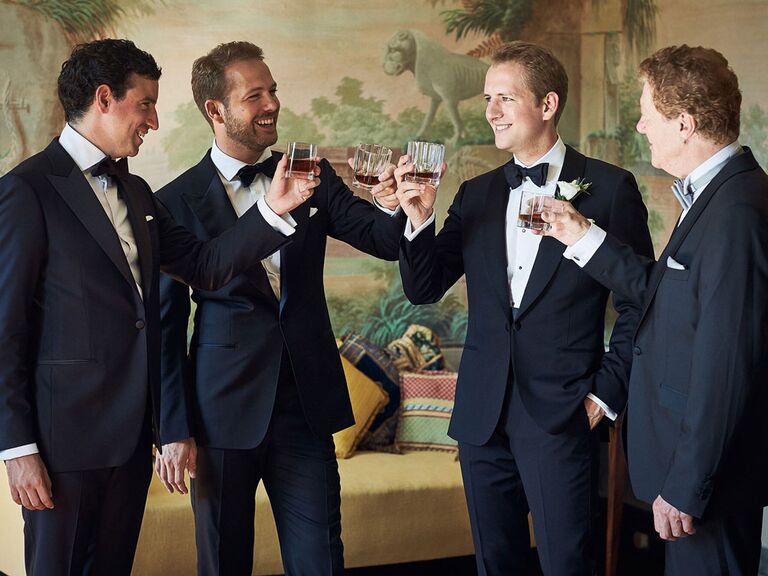 Groom and groomsmen toasting before the wedding ceremony