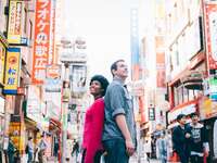 Couple posing back to back on their honeymoon