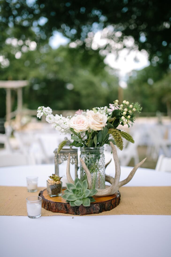 "I'm obsessed with flowers, lanterns and deer antlers, so I knew they were going to be a part of our decor," Tylar says. The wooden slabs came from a tree that fell over at Tylar's grandparents' home, which they cut and stained.