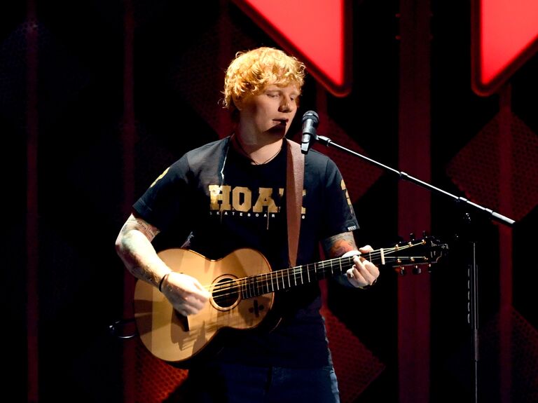 Ed Sheeran playing the guitar in concert
