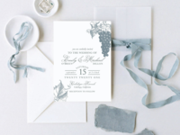 Blue gray grapes and leaf illustrations and elegant type on white background