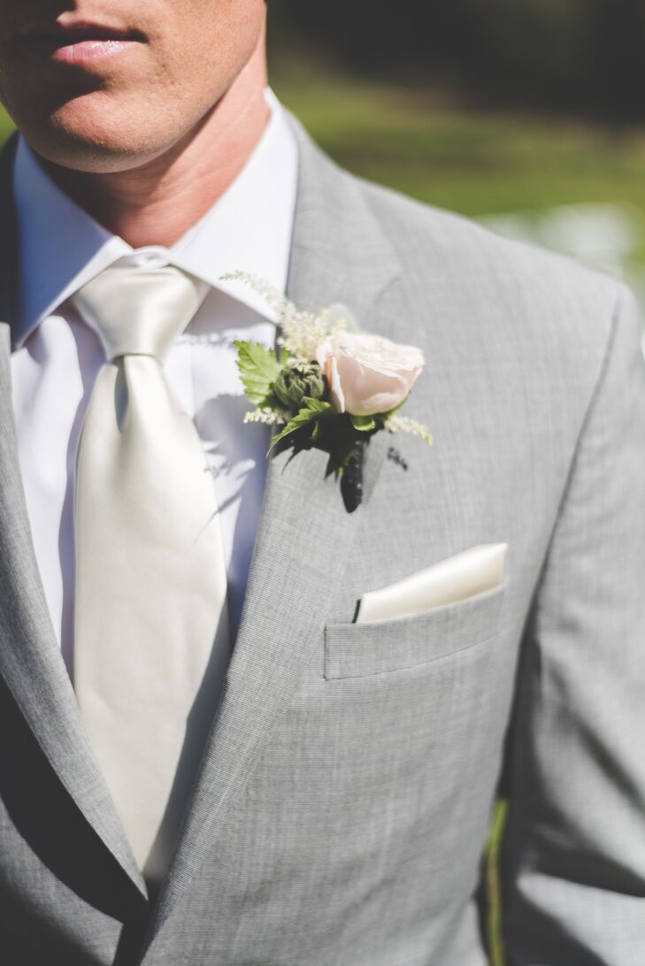 Kolton had a single blush rose pinned to his light gray jacket, which he wore with his ivory tie and pocket square.