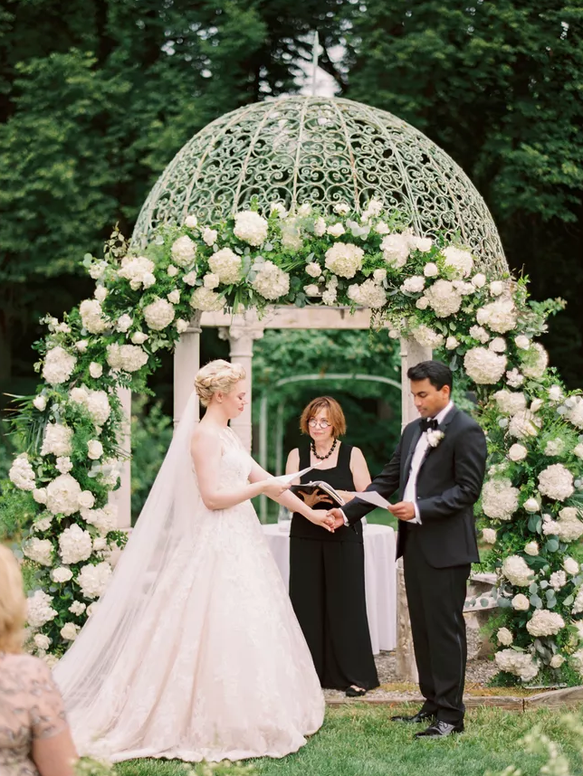 Couple with officiant during wedding ceremony