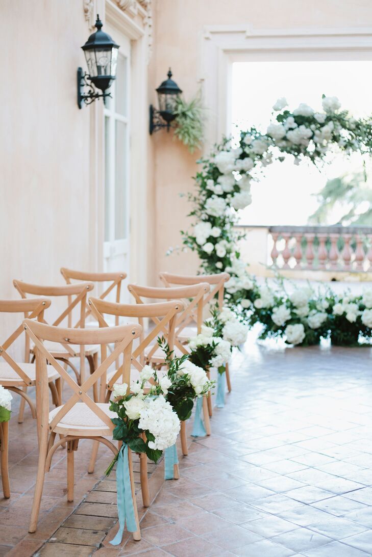 Elegant Ceremony with White Flower Arch and Aisle Decorations
