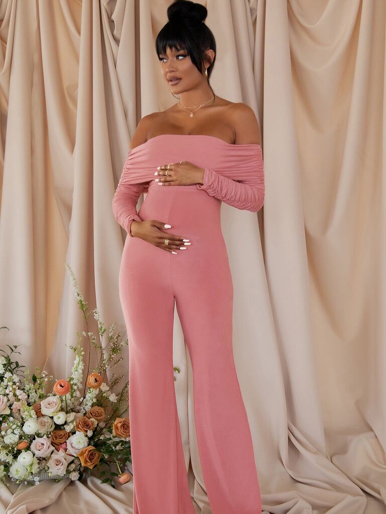 Model wearing a pink maternity jumpsuit off-the-shoulder long sleeves