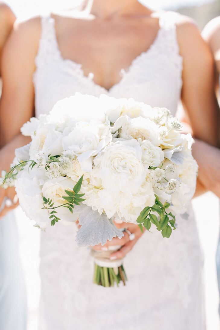 "My bridal bouquet was a breathtaking, hand-tied loose romantic round style, consisting of patience ivory roses, gardenias, garden roses, lisianthus, dusty miller and sprigs of greenery," Leah says. "I wanted a lot of white in various shades and textures and used the dusty miller to add a touch of light blue and velvet texture. I used a handkerchief from my grandmother to tie the flowers together."