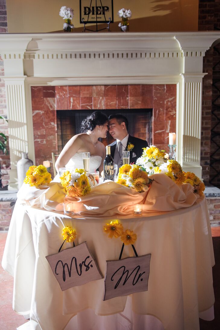 Lush yellow gerbera daisies decorated the couple's sweetheart table.