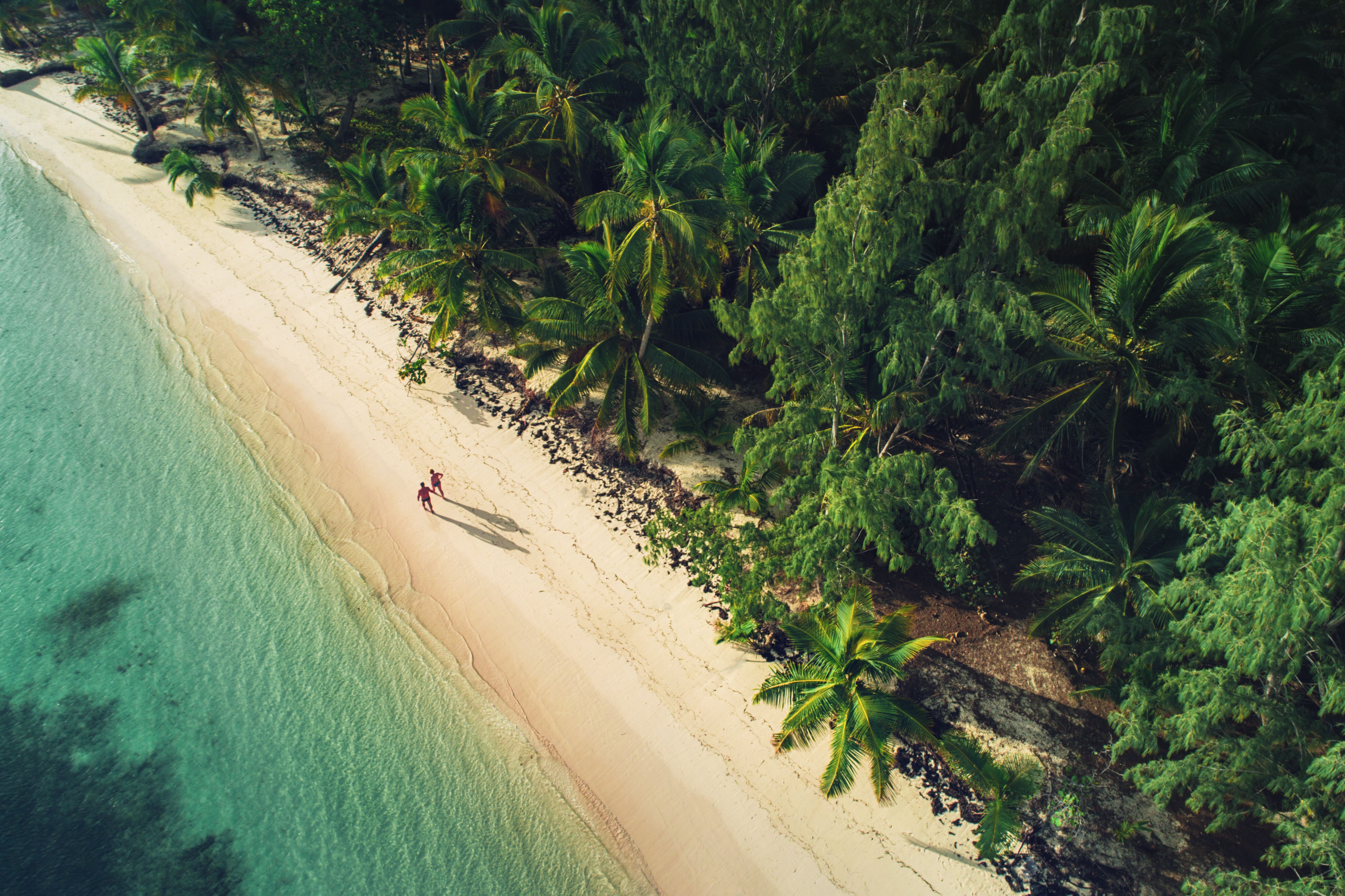 A couple walks along the inviting sands of a beach in the Dominican Republic.