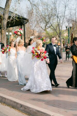 Bride and Groom With Bridesmaids in White and Mariachi Band Walk Down the Sidewalk