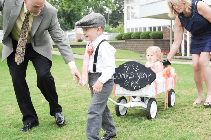 The ring bearer and flower girl processed together in a white wagon, complete with a sweet chalkboard sign.