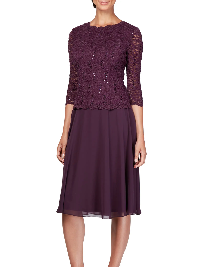 A model shows off a two-piece wedding guests dress in burgundy with a lacy top.