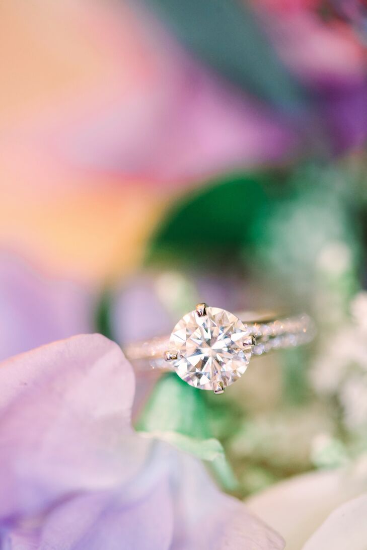 Anne's ring is a classic round-cut stone with a white gold band adorned in two rows of baguettes.