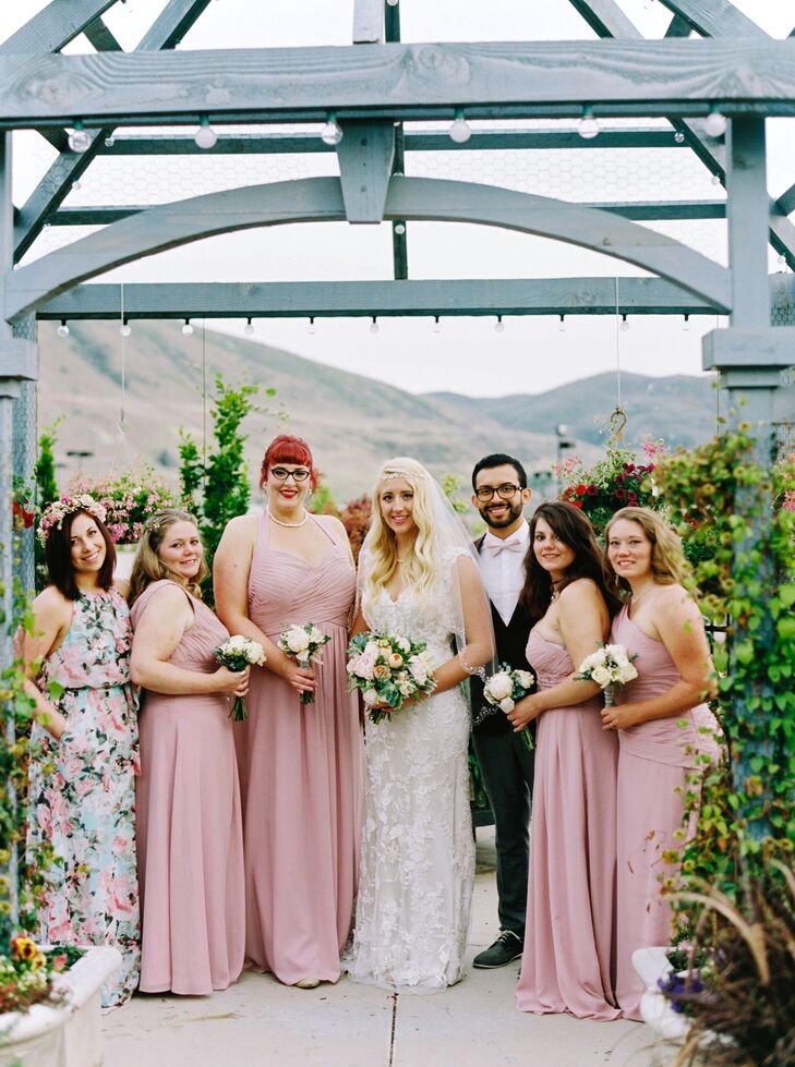 The bridesmaids chose a blush color for their dresses and chose their own. Lauren’s best guy friend was in her bridal party, too, and he wore a darker pink suit with a blush bow tie to match the bridesmaids. As for her flower girl, they improvised in a beautiful way: “There was a problem last minute with one of the bridesmaids dresses. With no time to order her another, we found a cute floral dress and turned her into a flower girl instead!” And may we just say, everyone looks so great together.