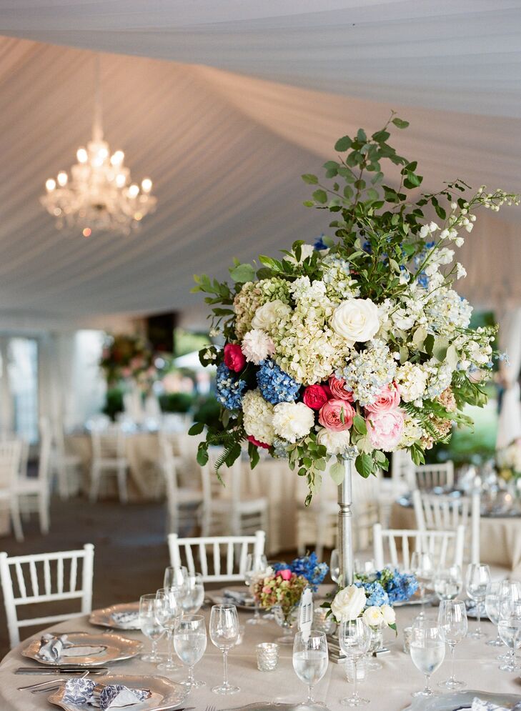 Extravagant high centerpieces filled with hydrangeas, roses, peonies and lily of the valley gave the reception tables an English garden party feel.