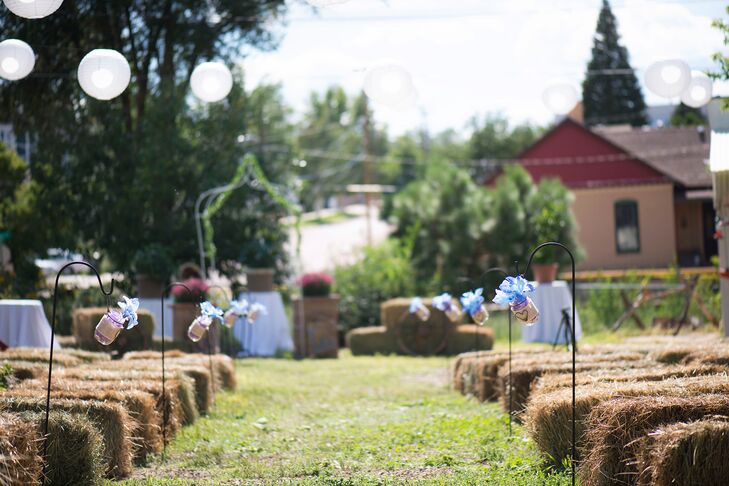 Lacey and her friends decorated the backyard wedding with mason jars, burlap, hay bales and paper lanterns for a casual feel.