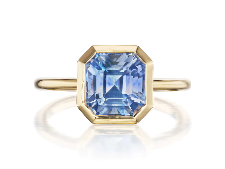 A gold band with a hexagonally-shaped sapphire.