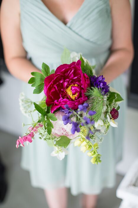 A large bright fuchsia peony was the center of the rustic bridesmaid bouquets.