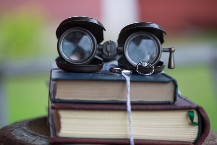 Vintage props like old books and antique binoculars added a whimsical touch to the wedding decor.