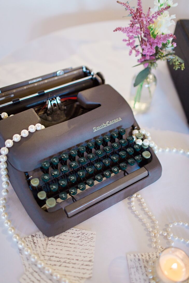 Inspired by a photo they found online, Alex and Bobby decorated their reception with a vintage typewriter, suitcases, stacked books and low mismatched floral centerpieces.