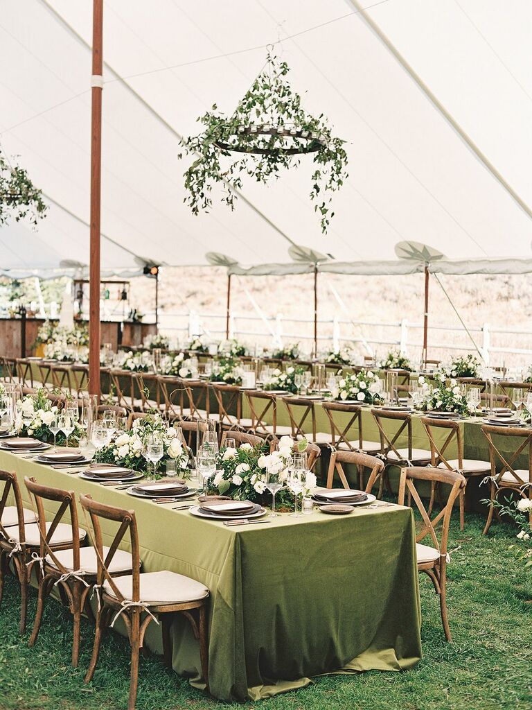 simple hanging wedding flowers with greenery vines on wrought iron chandelier