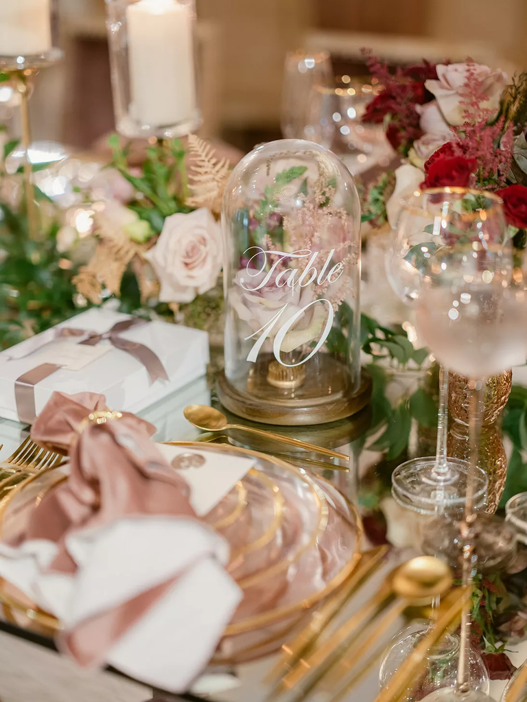 Flowers and glass cloche table numbers for your romantic wedding reception