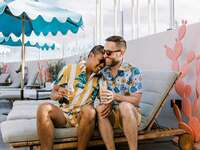 Grooms hugging during prewedding pool party