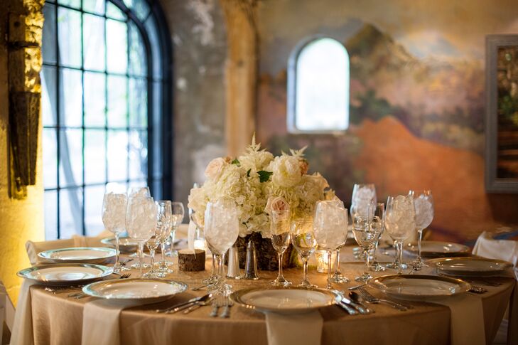 The round reception tables were topped with iridescent taffeta stardust linens with antique gold napkins.